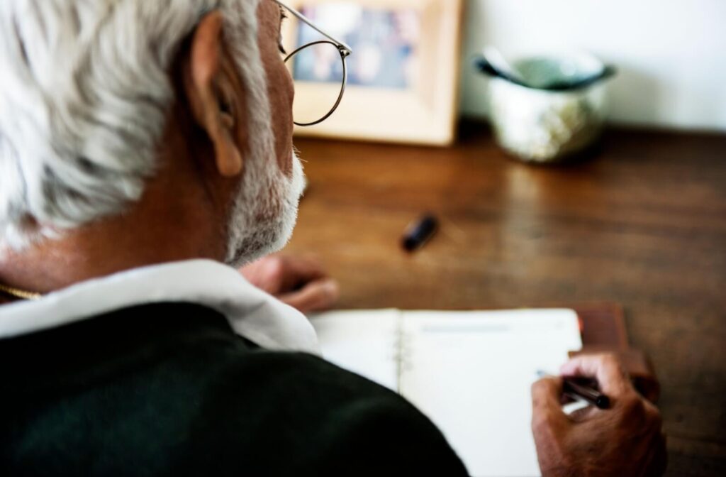 A senior spends some time reflecting and practicing gratitude through journaling
